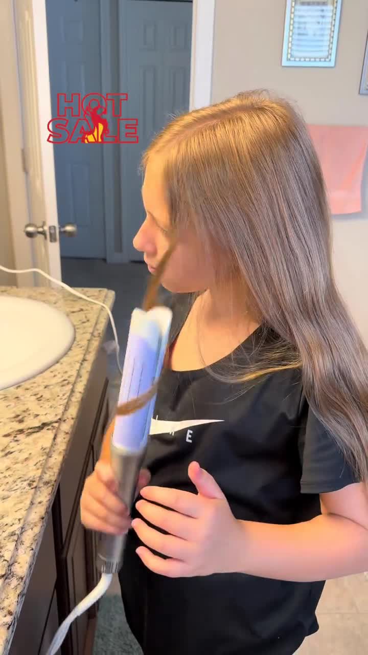 Side view of hair being styled with automatic rotating tool