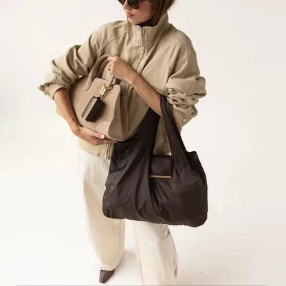 Woman carrying the foldable tote together with her everyday handbag